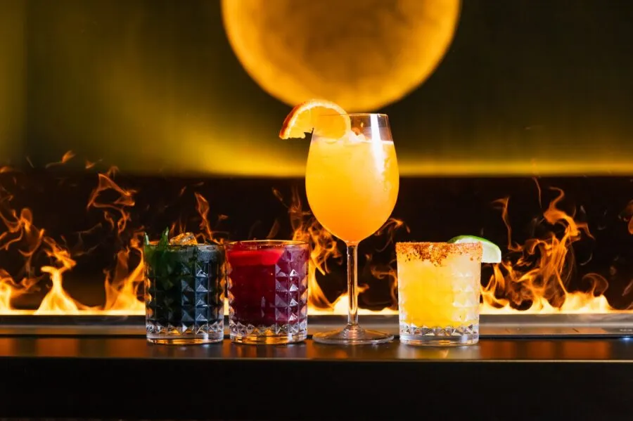 Cocktails and mocktails in front of the fireplace at the NRG Haus social bar